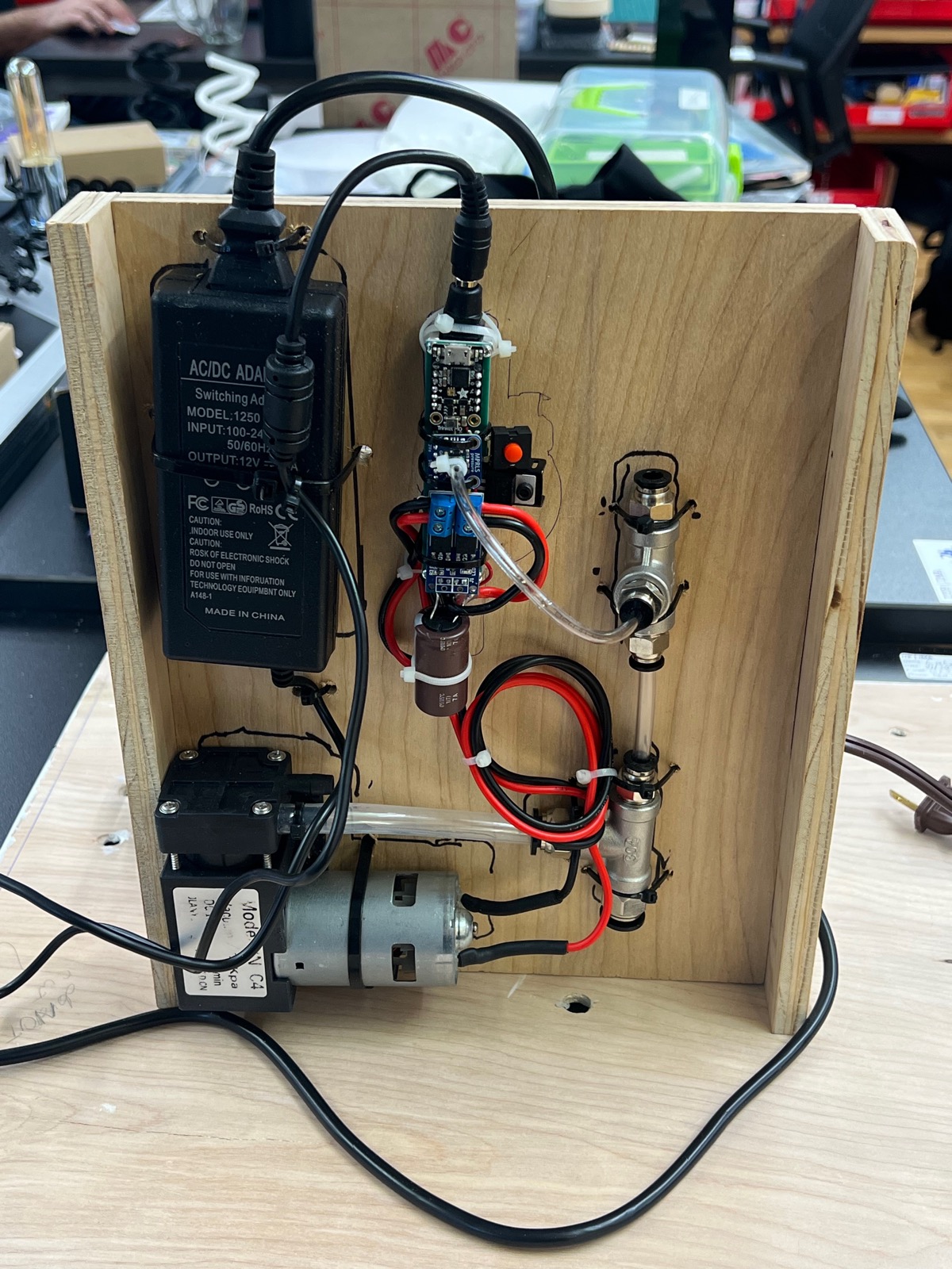 Pump and motor assembly mounted on wood board