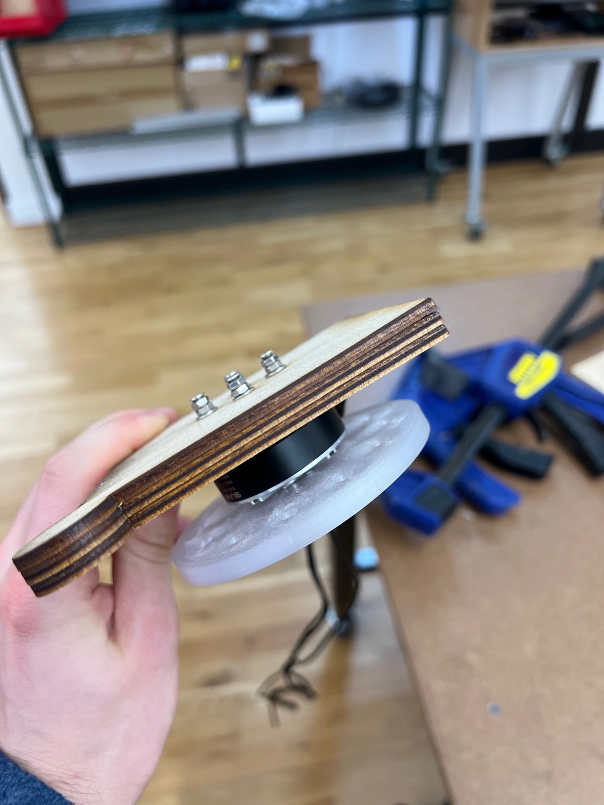 Plywood test panel with a BLDC motor and 3D-printed reaction wheel mounted