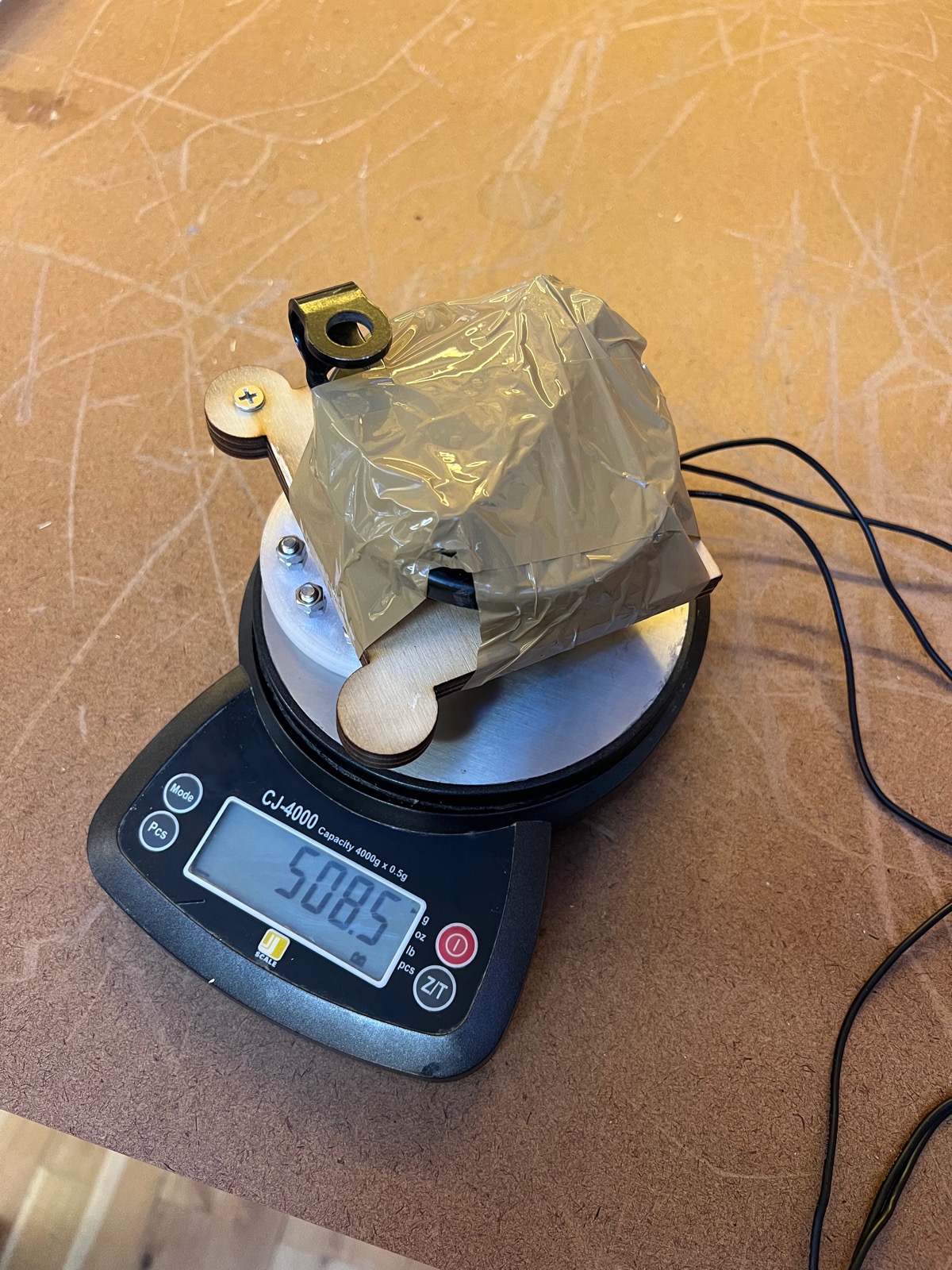Tape-wrapped payload on a kitchen scale reading 508.5 grams