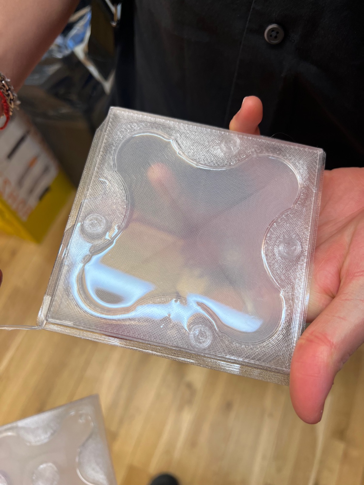 Hand holding a clear 3D-printed domed cube face panel