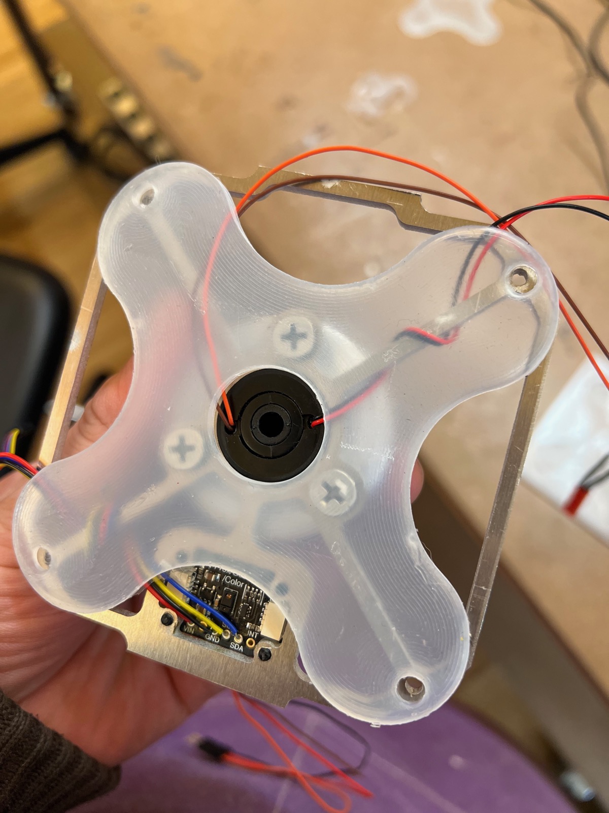 Clear 3D-printed cube face with the central motor hub and a sensor board