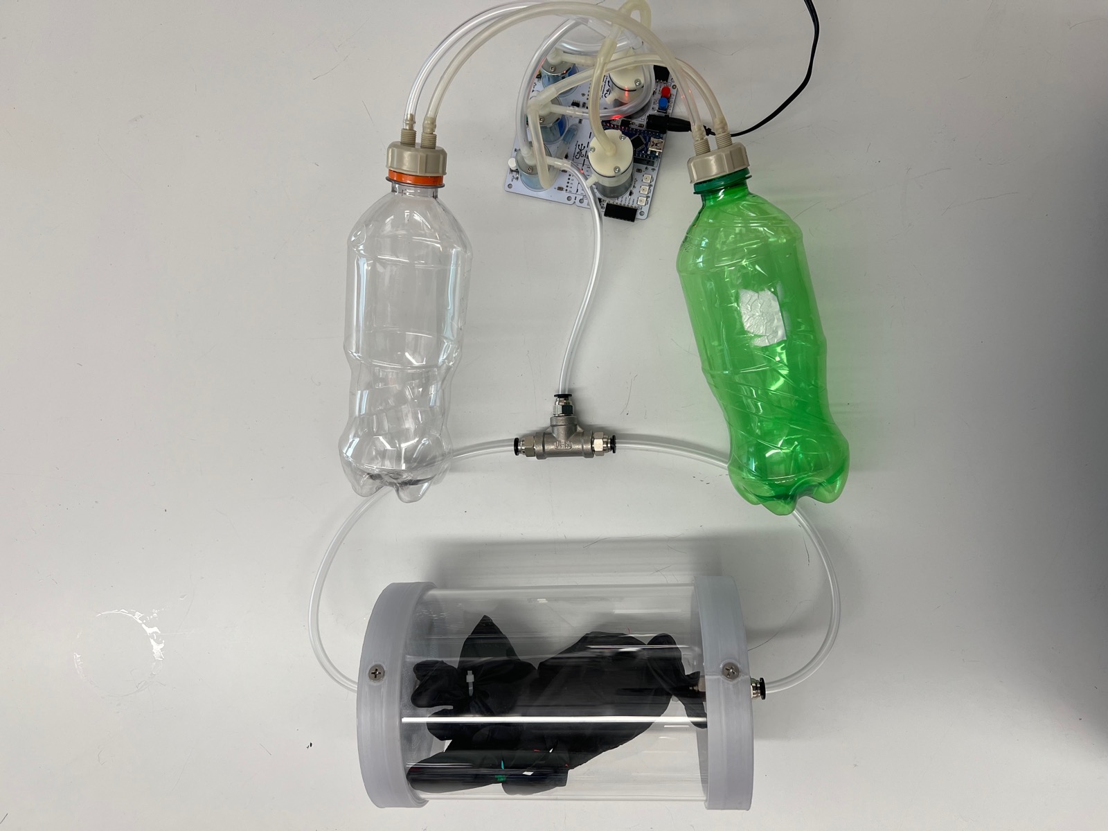 Overhead view of the complete Spacial Randomizer system with bottles, pump board, and chamber