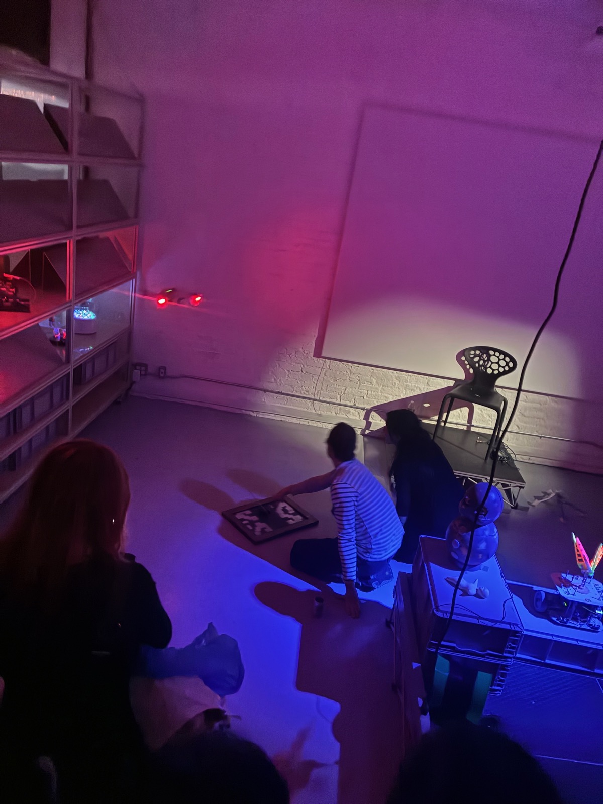 Performance space overview with audience and dramatic lighting